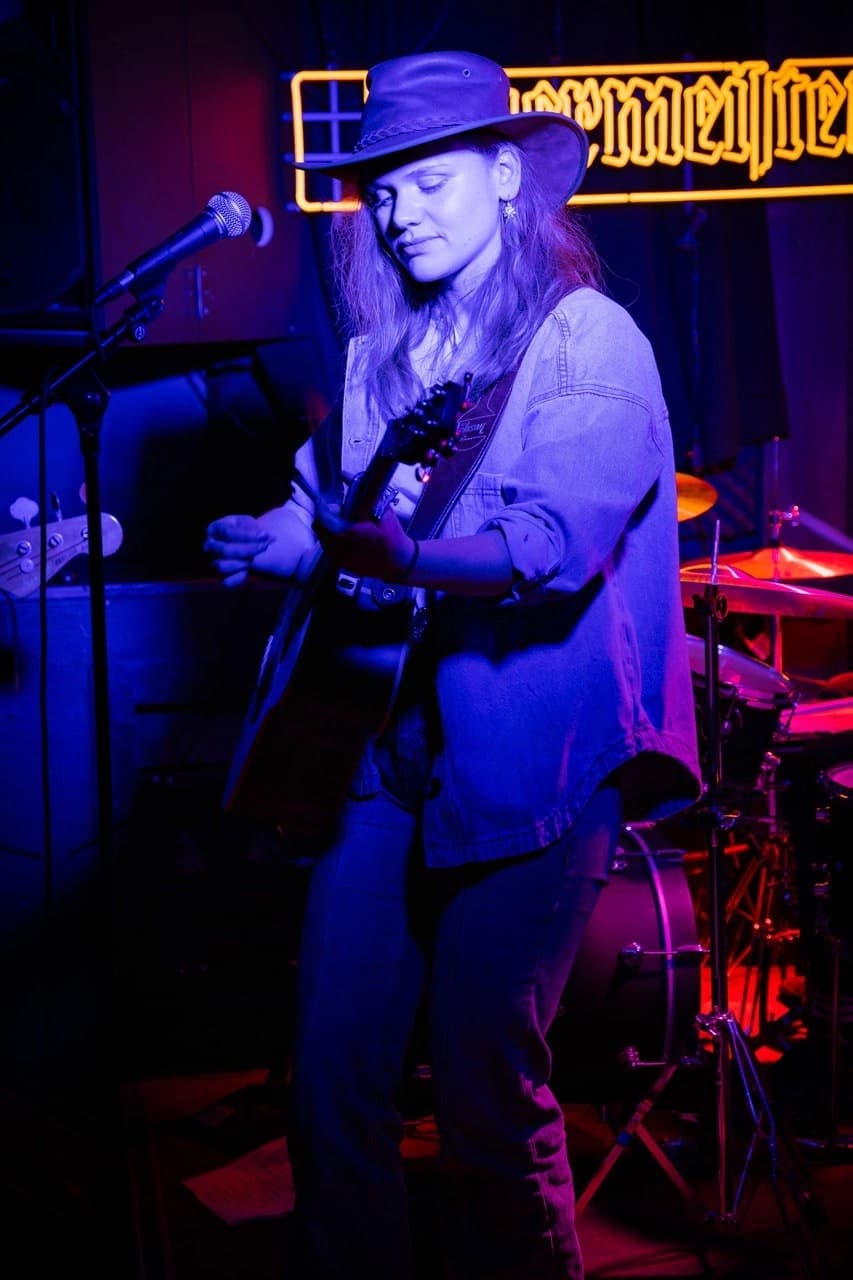 Cécile Gardens on stage during a live performance.